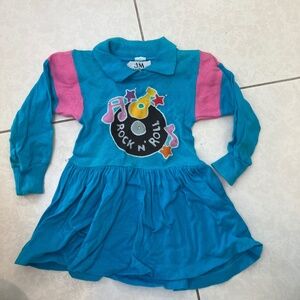 Adorable girls blue dress with rock ‘n’ roll theme